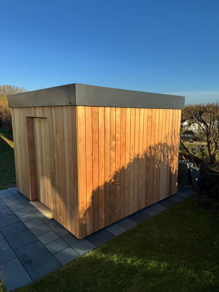 A finished cedar-clad garden building by Cribbar Construction, Cornwall